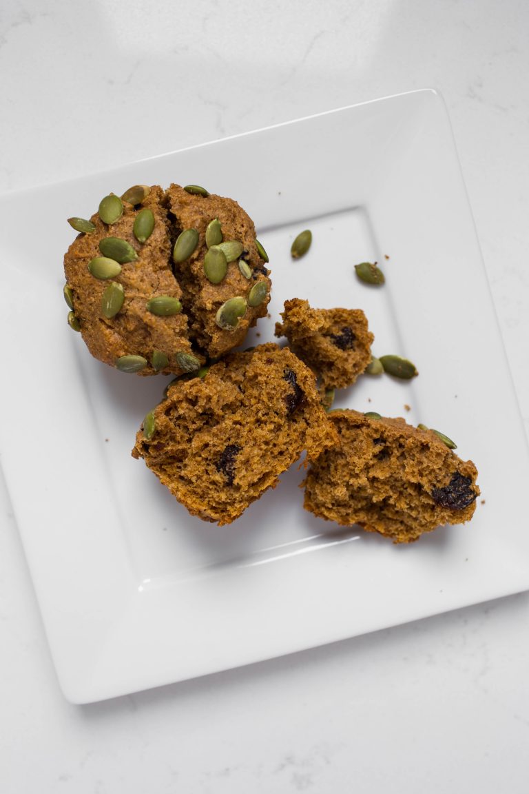 Cut open vegan pumpkin muffin with pumpkin seeds