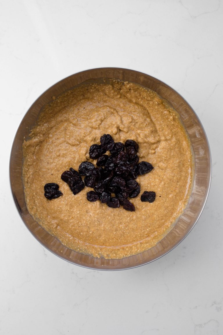 Pumpkin batter with dried cherries in bowl