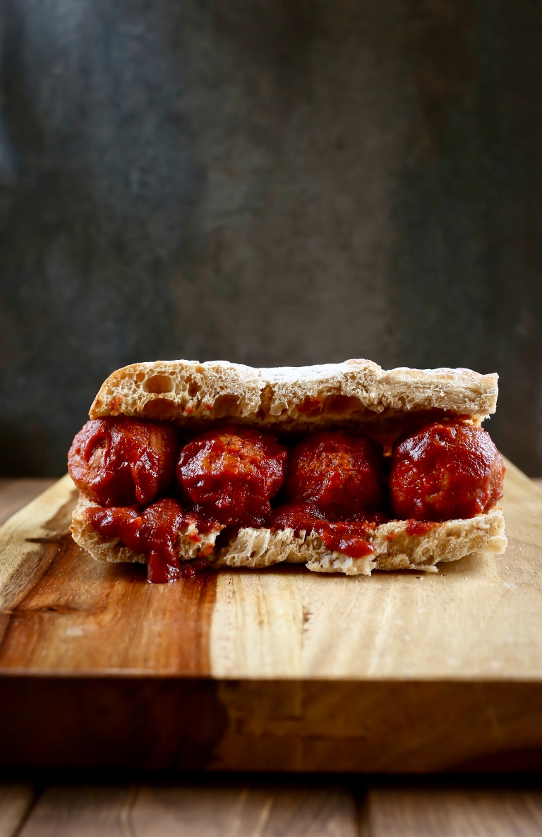 Vegan barbecue sub sandwich on wood board