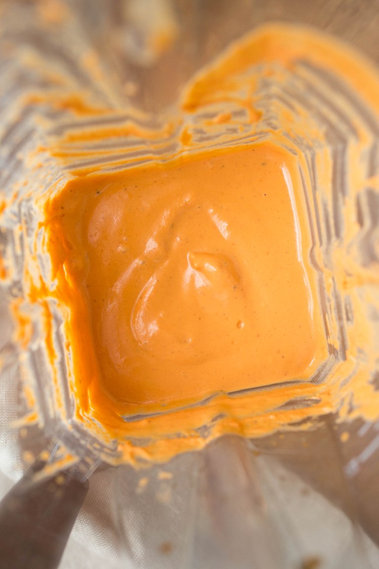 Blender containing blended vegan pimento cream sauce.