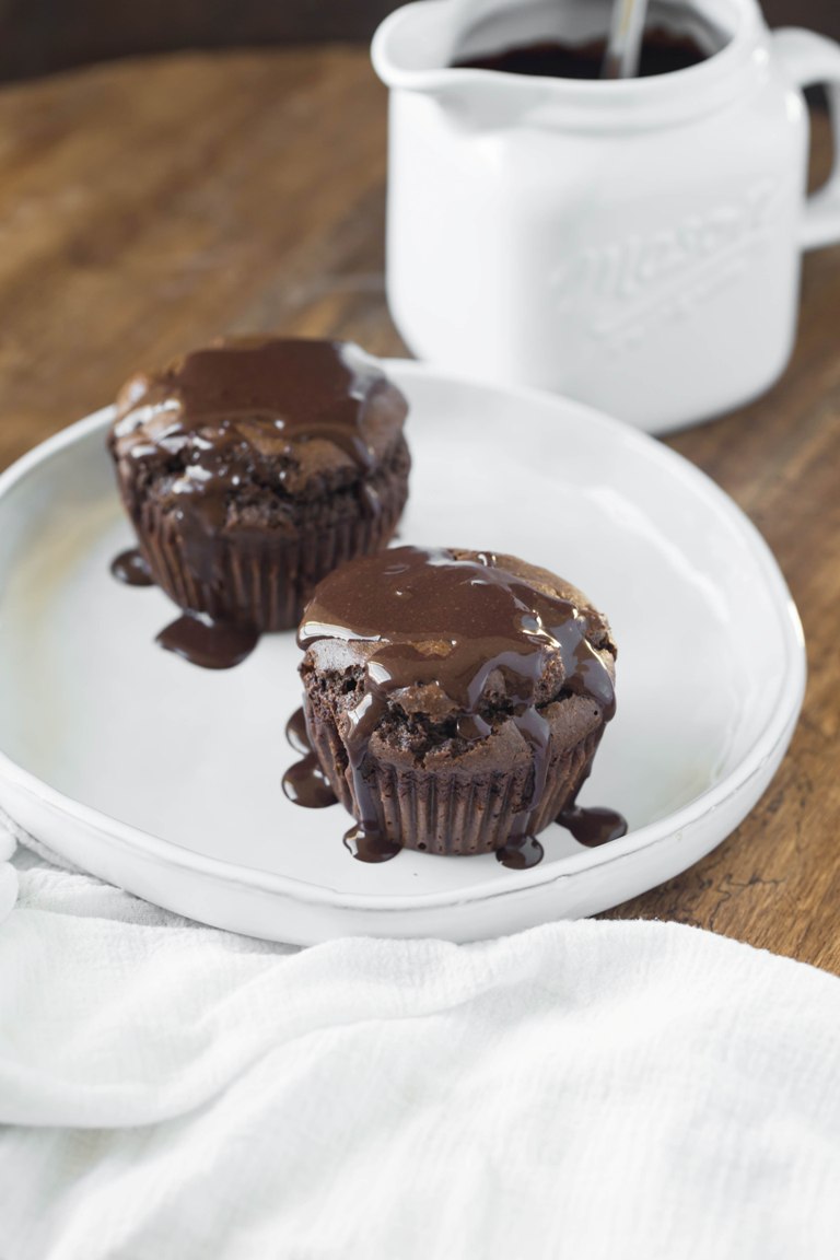 2 chocolate muffins with chocolate sauce
