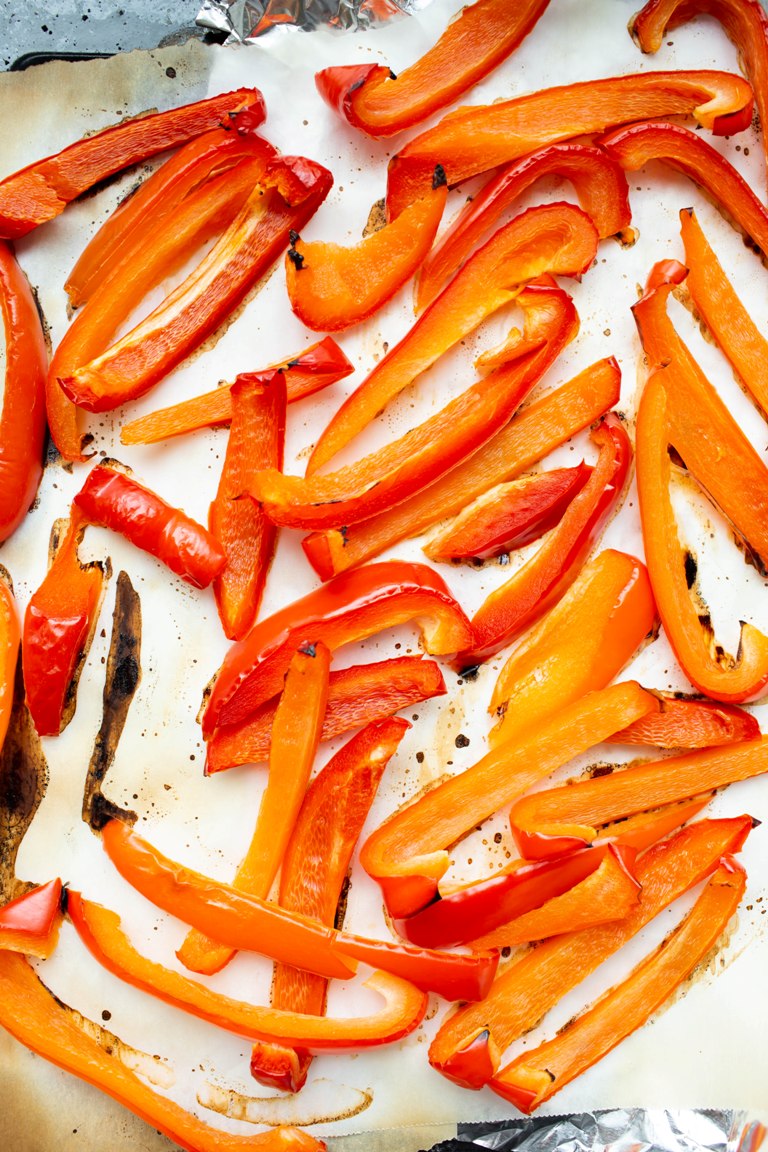 Roasted red bell pepper strips on pan
