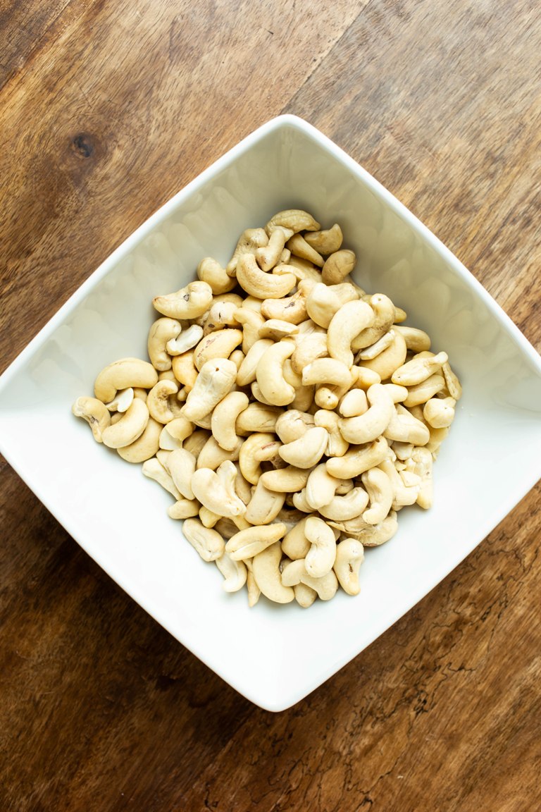 white bowl of raw cashews