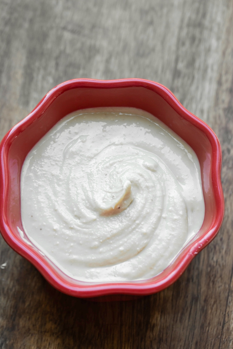 creamy smooth raw cashew butter in red bowl