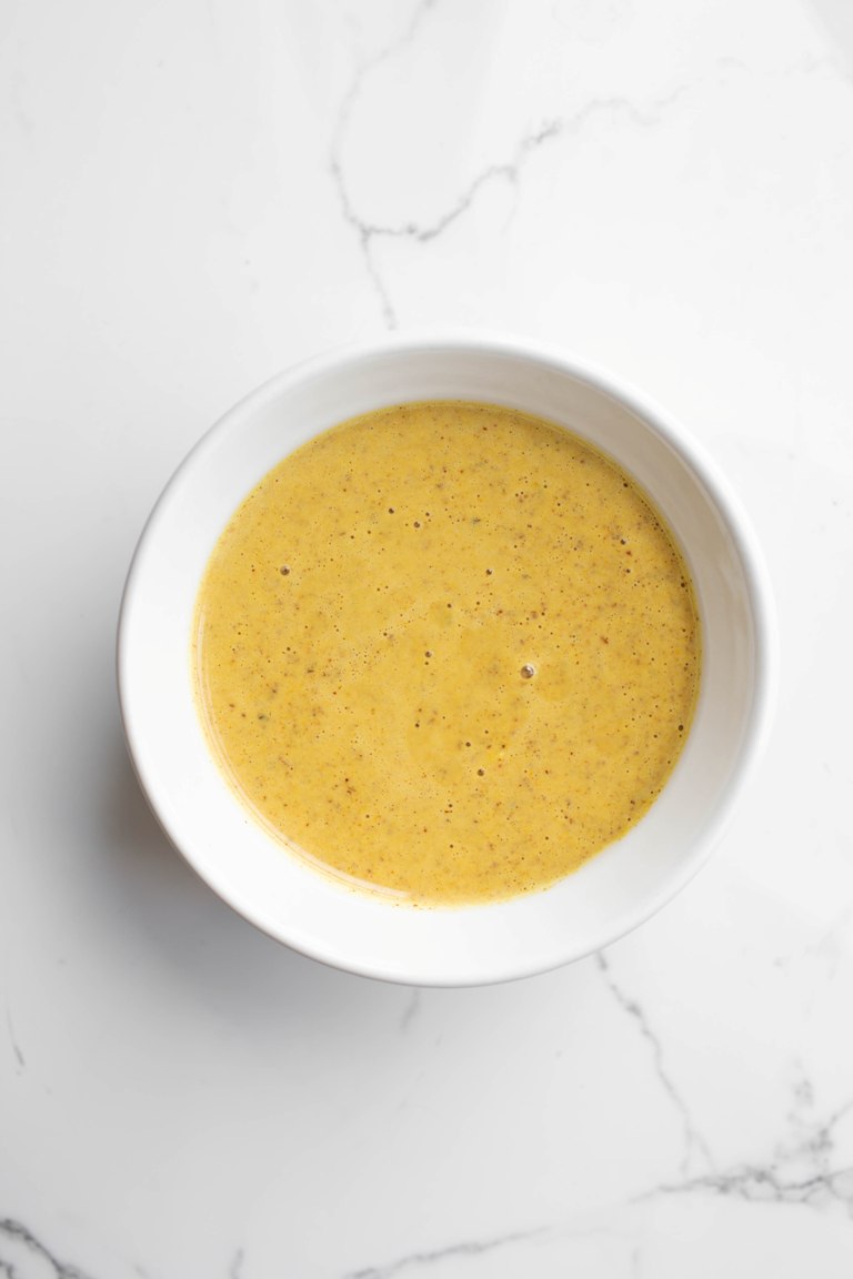 lemon ginger sauce in white bowl on white marble