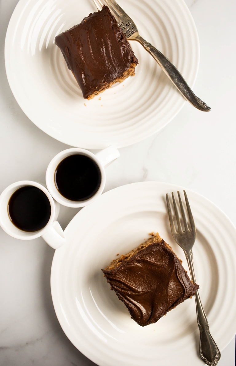 2 white plates with cake and 2 cups of coffee