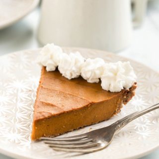 vegan pumpkin pie with whipped cream on top