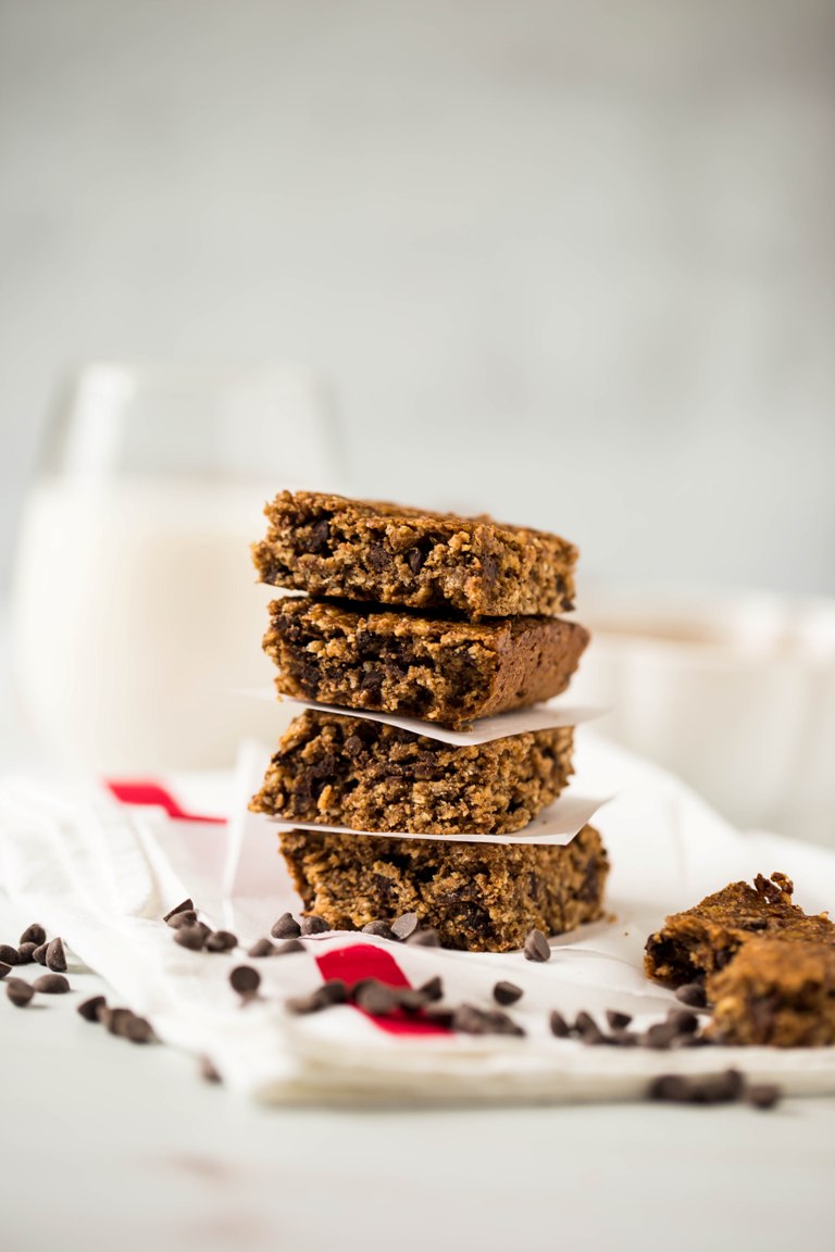 stack of vegan gluten free chocolate chip granola bars with glass of milk