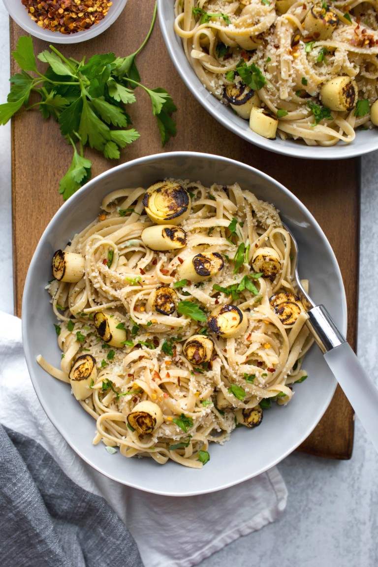 gray bowl of vegan scampi with breadcrumbs and fresh parsley