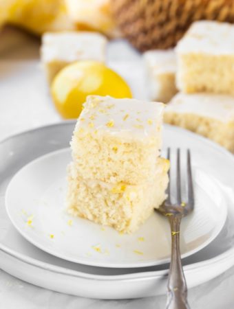 2 slices of lemon cake stacked on each other on white plate