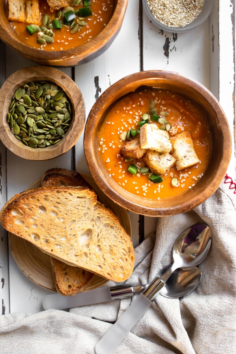 2 bowls of zucchini soup with grilled cheese on white tray