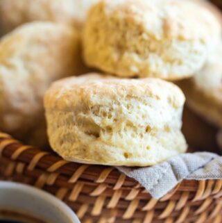 several biscuits in wicker basket with cup of coffee