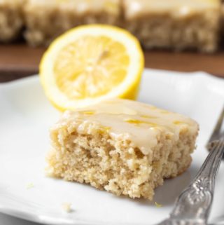 slice of lemon cake with fork on white plate