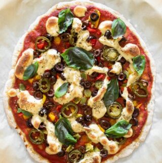 whole baked pizza with toppings and vegan mozzarella