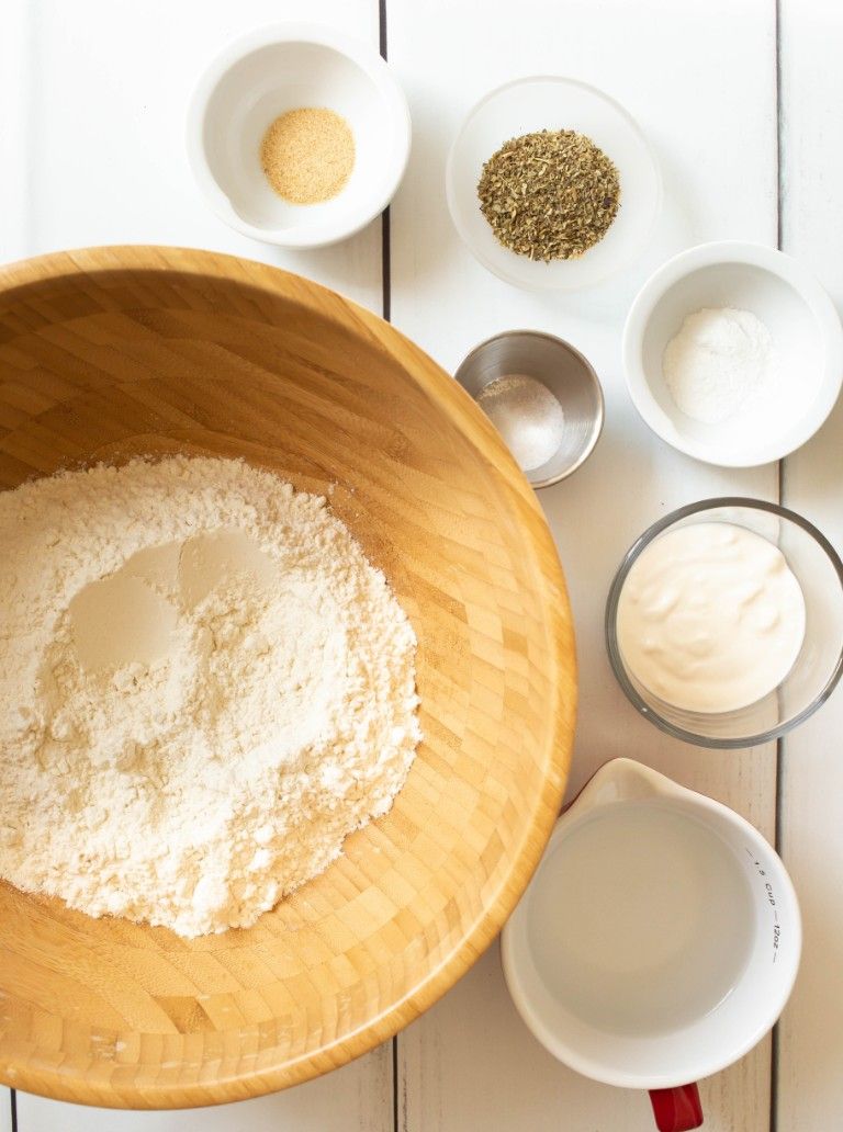 ingredients for pizza dough on white wood table