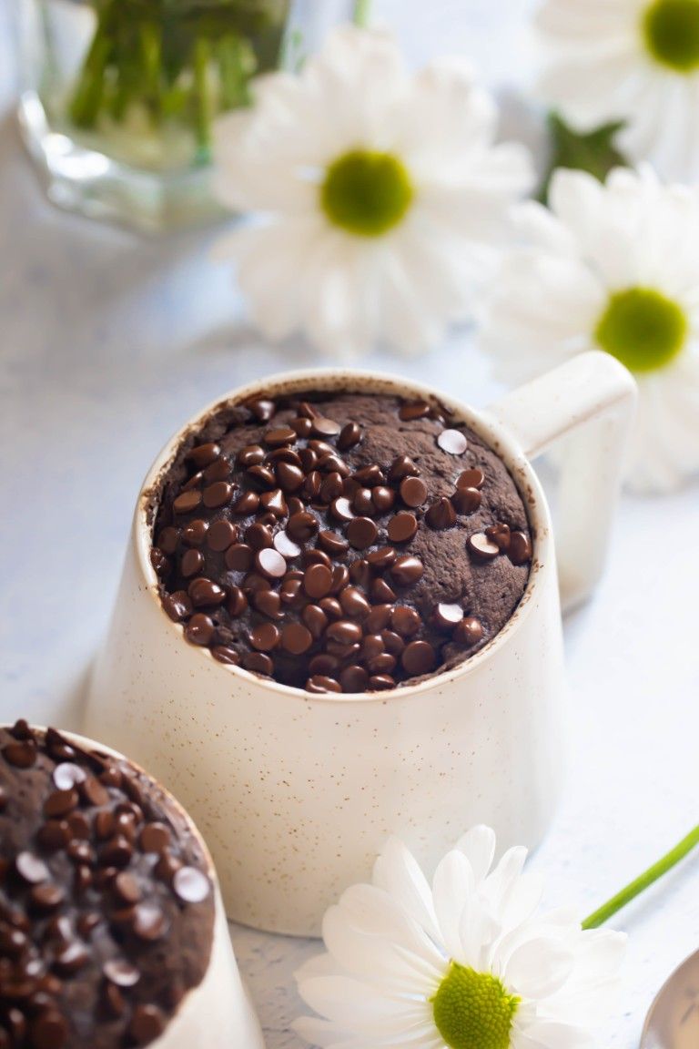 mug cake with white flowers around it