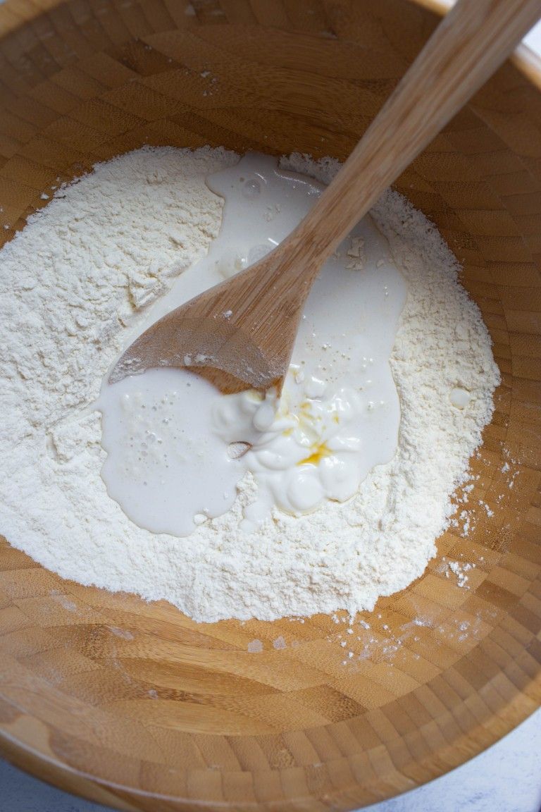 wood bowl of flour yogurt and coconut milk