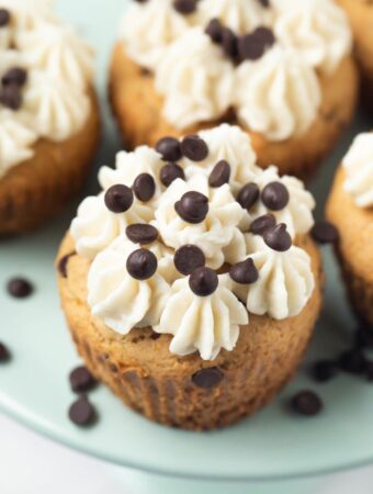 closeup shot of chocolate chip cupcake with frosting on top