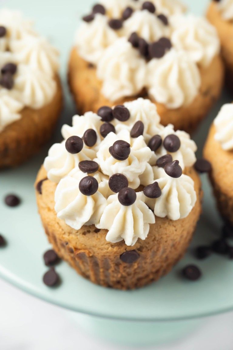 closeup shot of chocolate chip cupcake with frosting on top