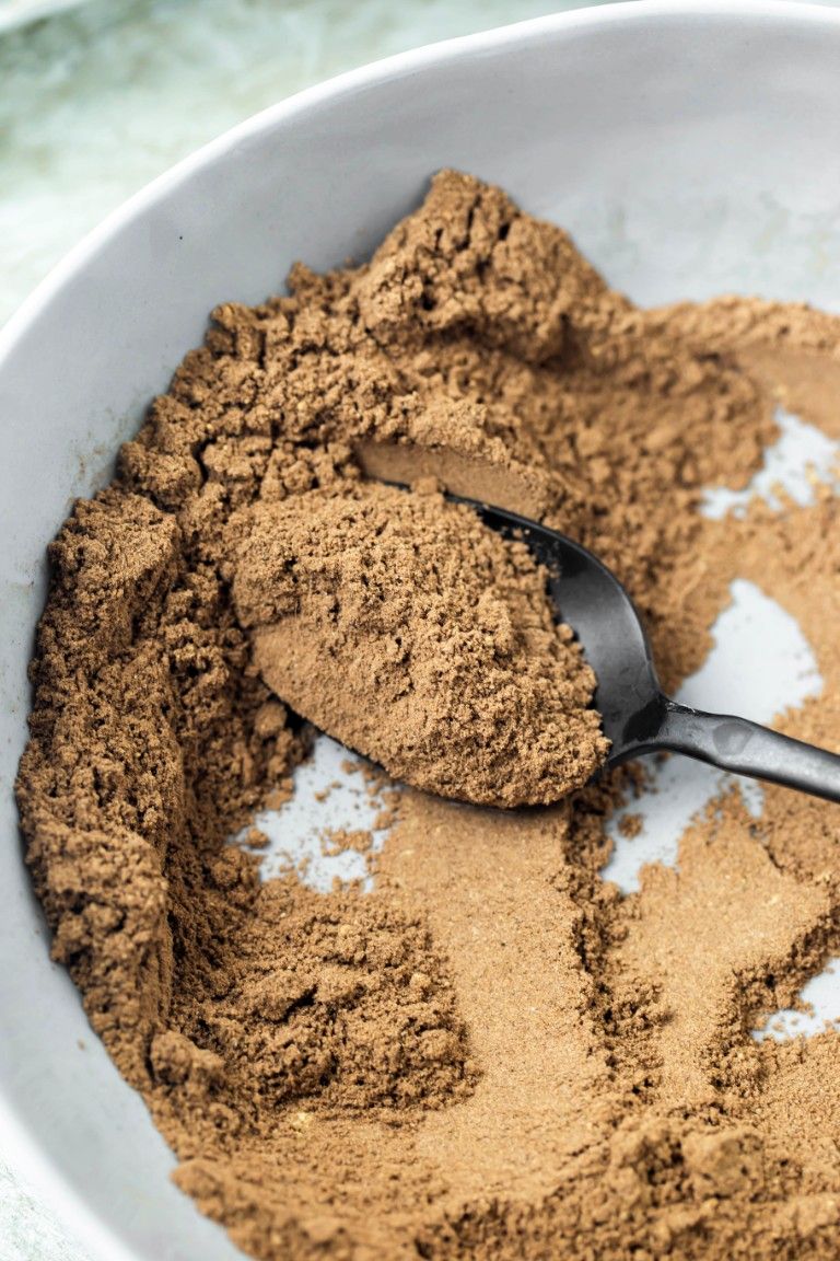 mixed up chai spices with black spoon in bowl