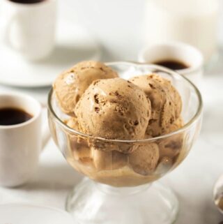 several scoops of vegan butterscotch ice cream in glass bowl