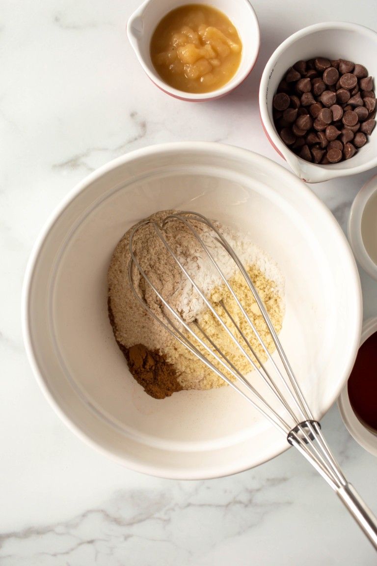 dry ingredients with whisk in white bowl