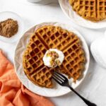 plate of waffles with dairy-free yogurt and syrup