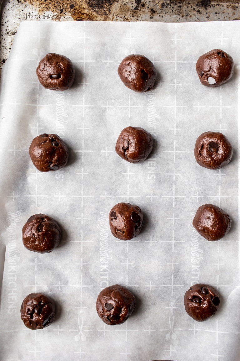cookie batter rolled into balls on pan before baking