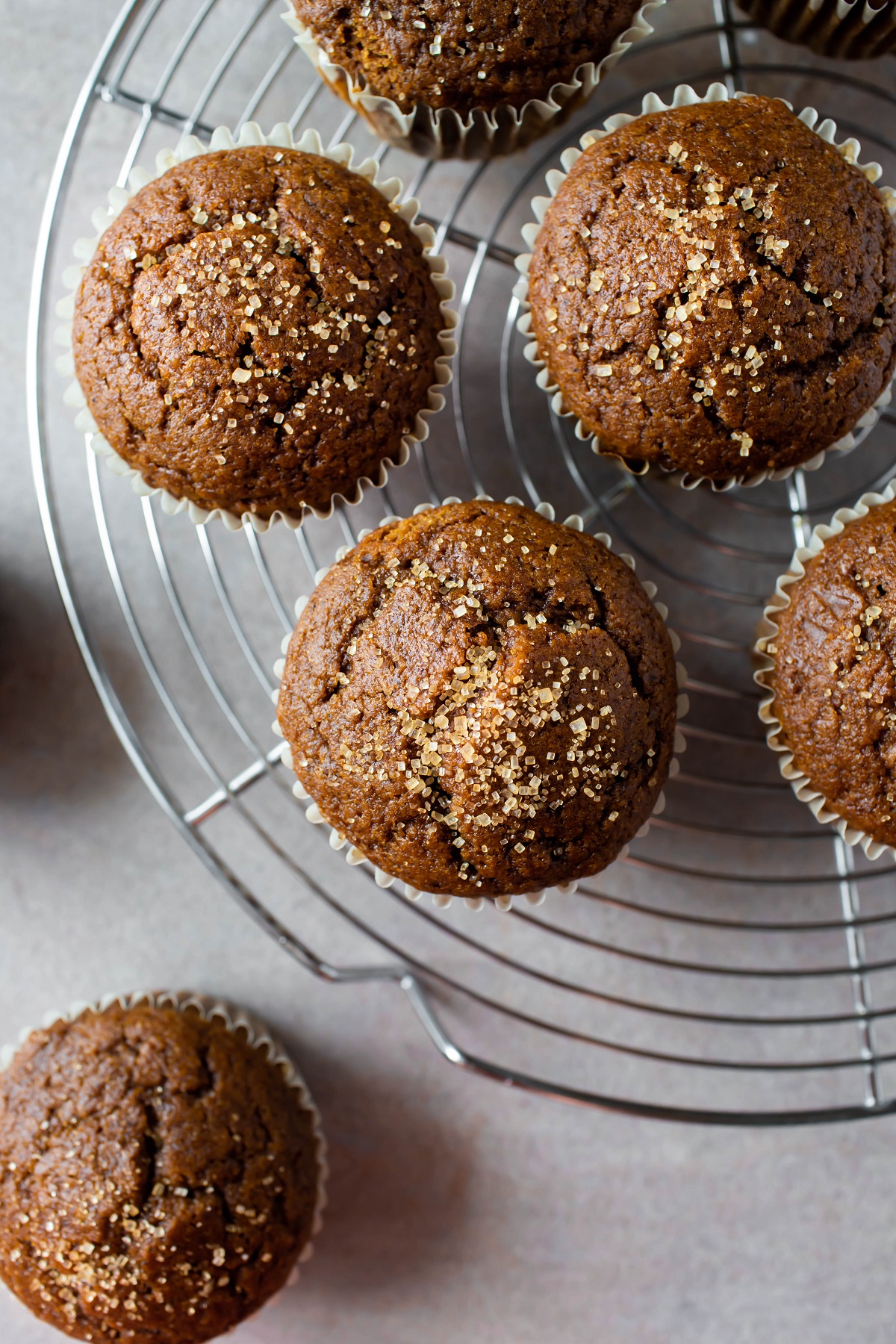 vegan gingerbread muffins on cooling rack with raw sugar on top